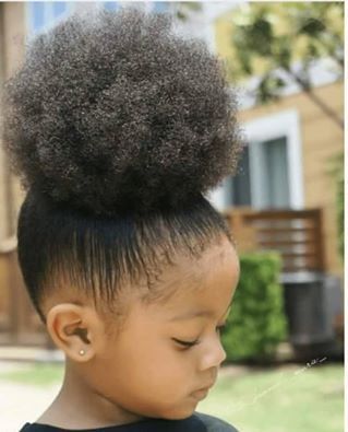 Little girl with a high natural hair puff hairstyle