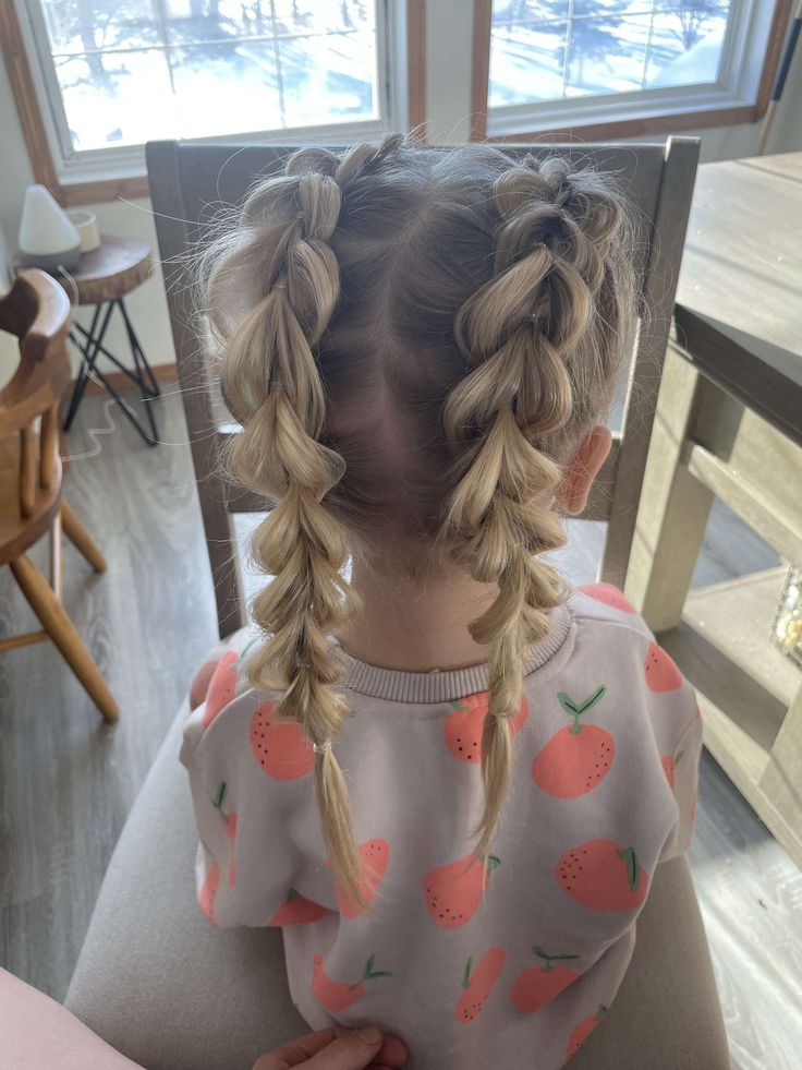 Girl with two chunky pull-through braid pigtails