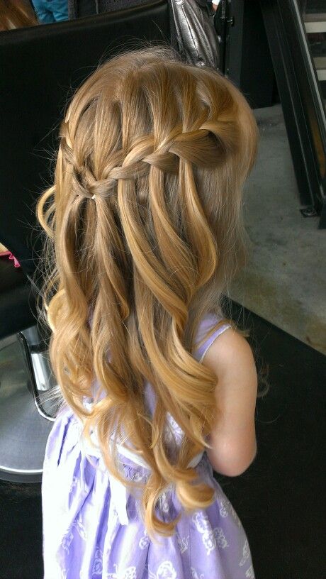 Young girl with a waterfall braid across the back, hair curled underneath in loose ringlets