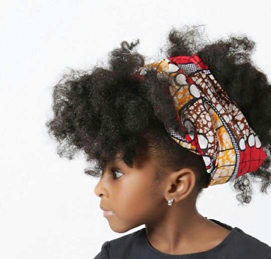 Child with a full afro and colorful printed headwrap