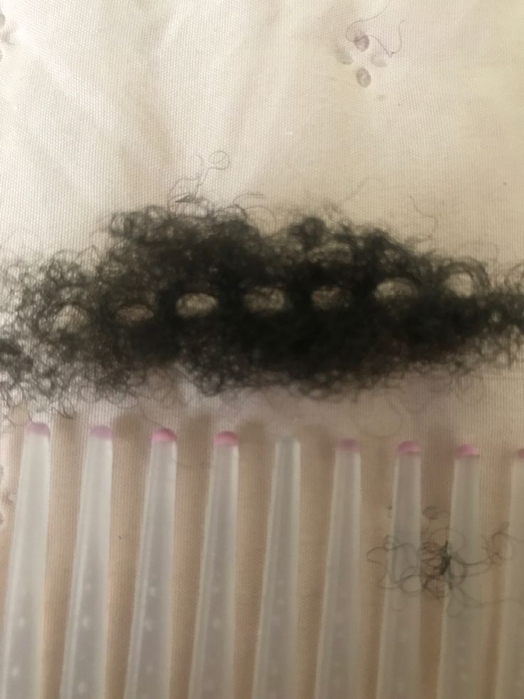 Close-up of a clump of hair caught in a wide-tooth comb