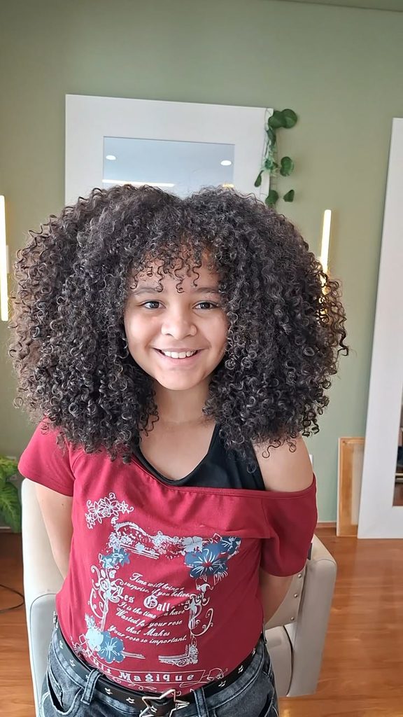 Smiling girl with voluminous diffused curly hair