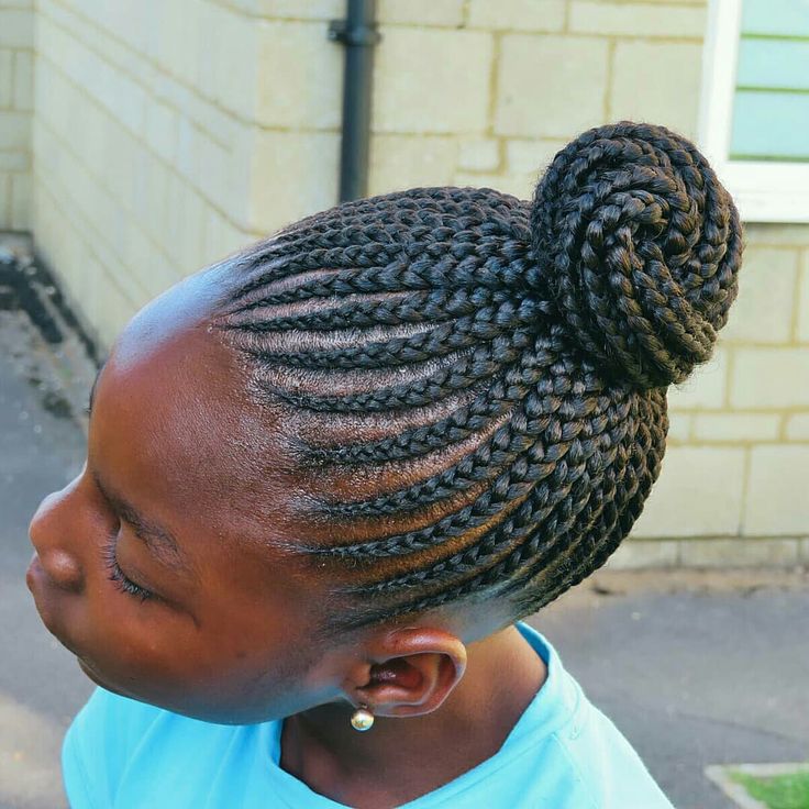 Close-up of a child's cornrow braids with colorful beads at the ends.