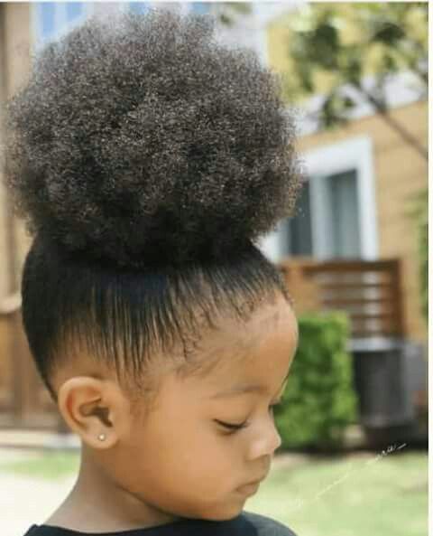 Girl with a high afro puff hairstyle.
