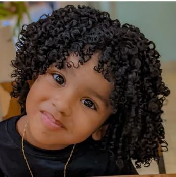 Young child with curly fringe framing the face