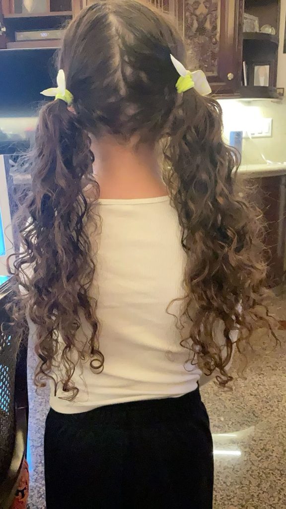 Back view of long low curly pigtails