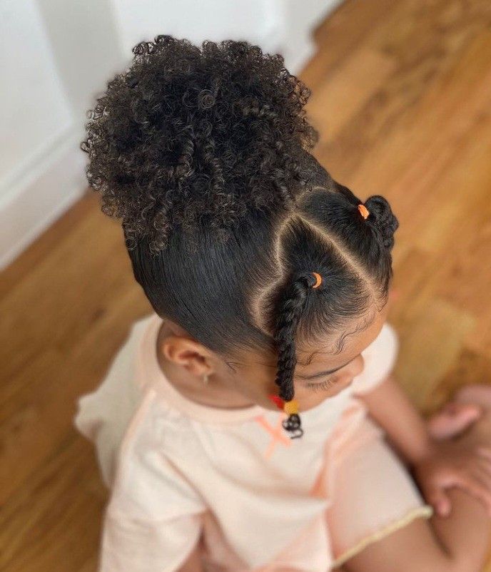 Little girl with a curly pineapple ponytail hairstyle