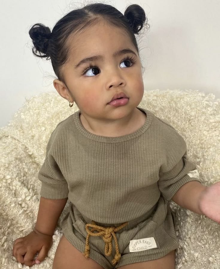 Toddler with hair in two space buns