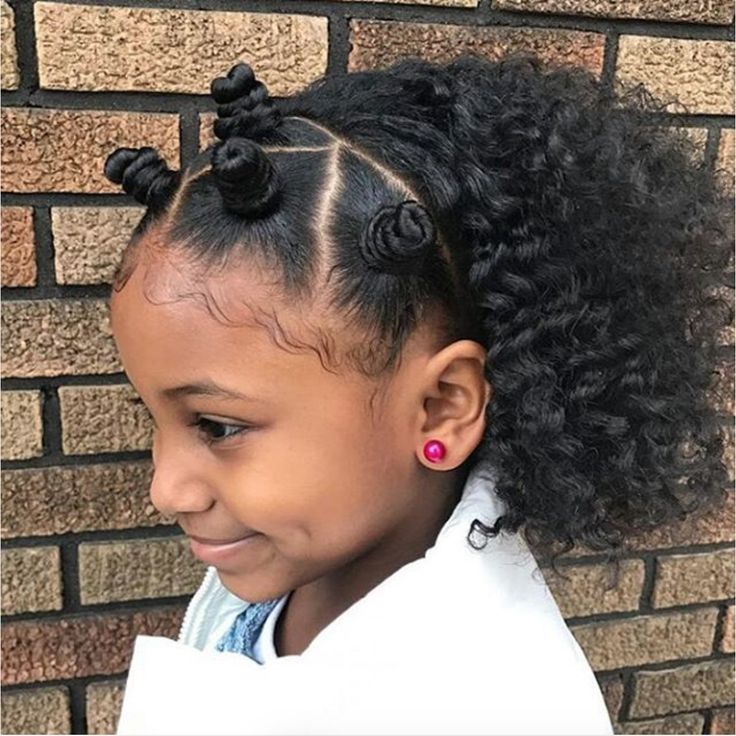 Child with bantu knots at the crown and curly hair left down