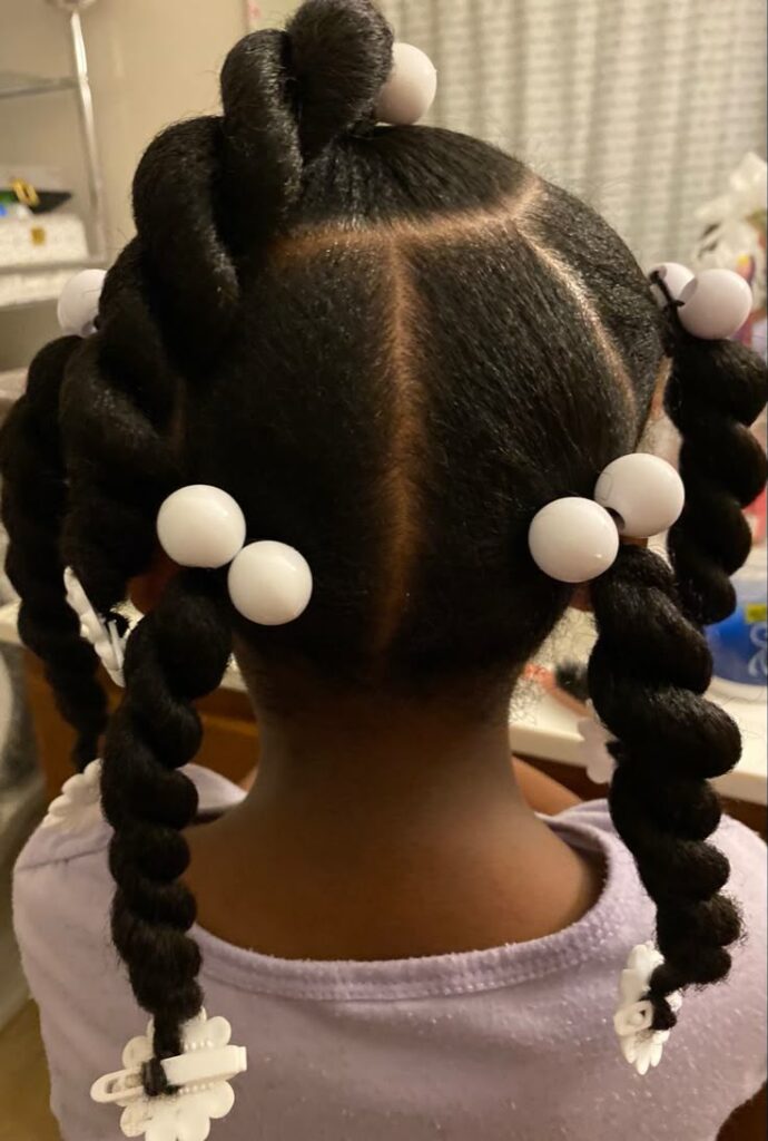 Child with chunky twists and white bead accents