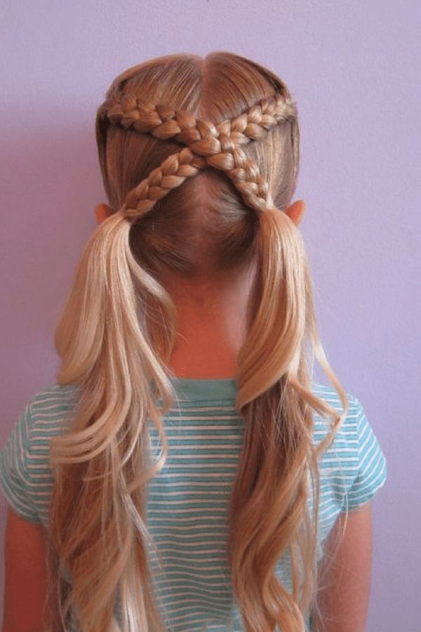 Girl with two braids crossing over the back of her head into low pigtails.