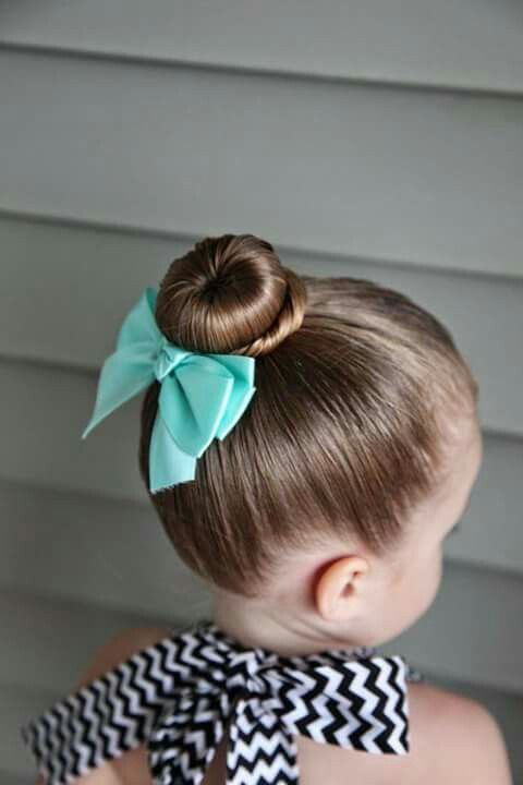 Girl with a smooth donut bun tied with a mint green bow