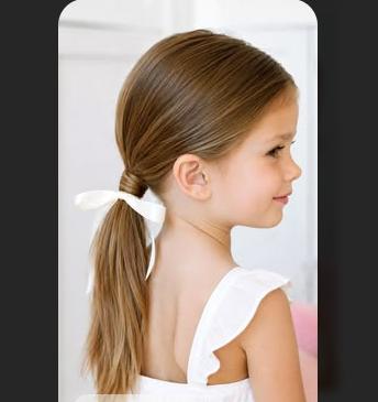Girl with a smooth low ponytail tied with a white ribbon