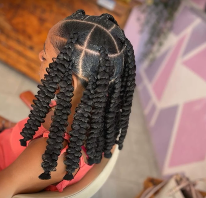 Child with butterfly braids parted into sections