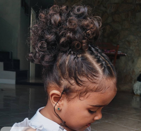 Girl with curly flower-shaped bun updo, side profile
