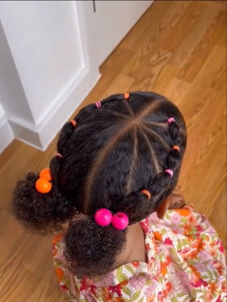 Child with rubber band bubble pigtails and colorful bead accents